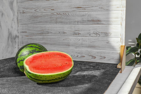 Fresh juicy watermelon and double-sided backdrops on table in photo studio. Space for textの写真素材