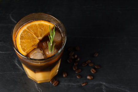 Tasty refreshing drink with coffee and orange juice on gray table, space for textの写真素材