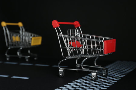 competition concept. Shopping carts racing towards the finish lineの写真素材