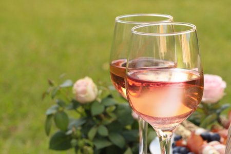 Glasses of delicious rose wine and food outdoors, closeupの写真素材