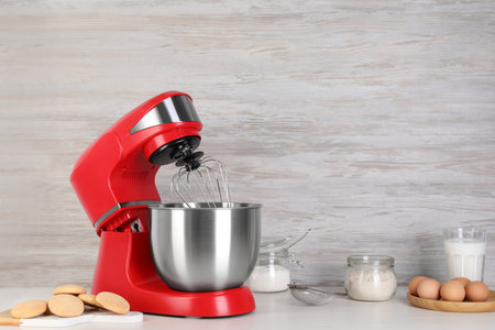 Composition with modern red stand mixer and different products on white tableの写真素材