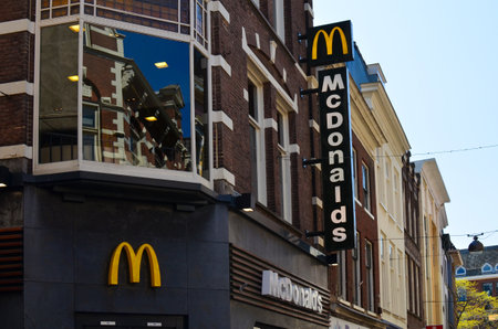 Hague, Netherlands - May 2, 2022: Exterior of Mcdonald's fastfood restaurant on city streetのeditorial素材