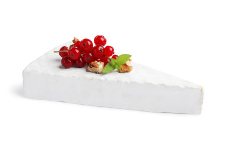 Brie cheese served with red currants and walnuts isolated on whiteの写真素材