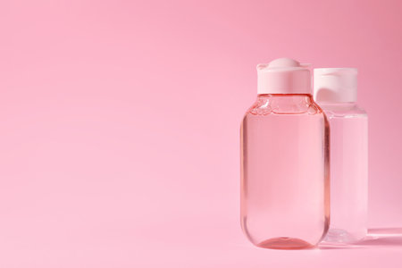 Bottles of micellar water on pink background. Space for textの写真素材