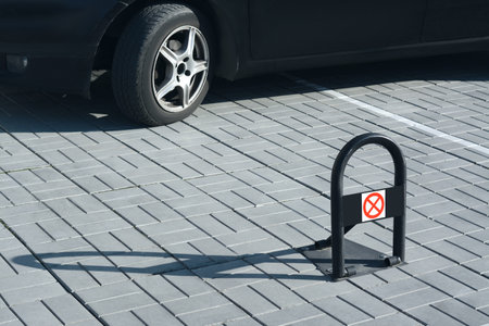 Parking barrier with No Stopping road sign on pavement near car, space for textの写真素材