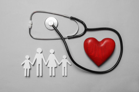 Paper family cutout, red heart and stethoscope on gray background, flat lay. insurance conceptの写真素材