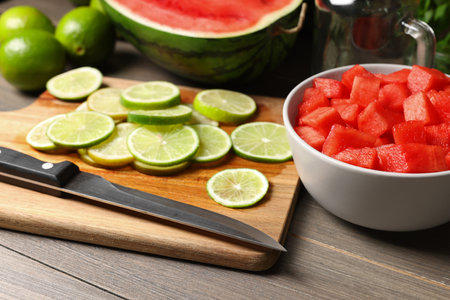 Fresh ingredients for making watermelon drink with lime on wooden tableの写真素材