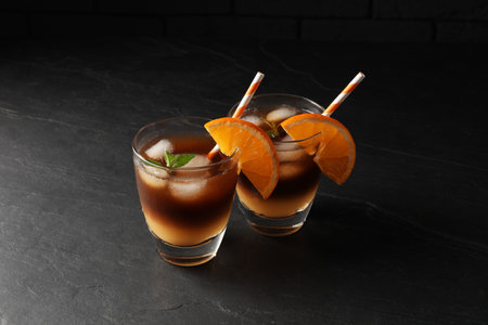 Tasty refreshing drink with coffee and orange juice on gray tableの写真素材
