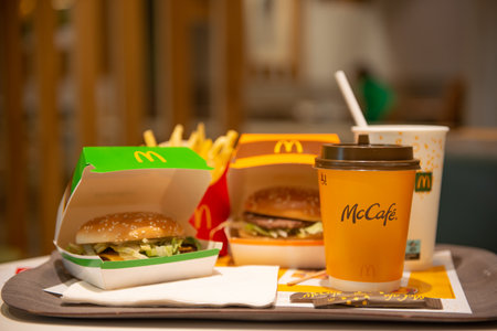 WARSAW, POLAND - SEPTEMBER 04, 2022: McDonald's French fries, burgers and drinks on table indoorsのeditorial素材