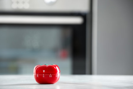 Kitchen timer in shape of tomato on light gray table indoors. Space for text