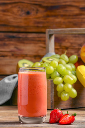 Glass with tasty smoothie on wooden tableの写真素材