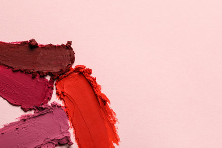 Smears of different bright lipsticks on light background, top view. Space for textの写真素材