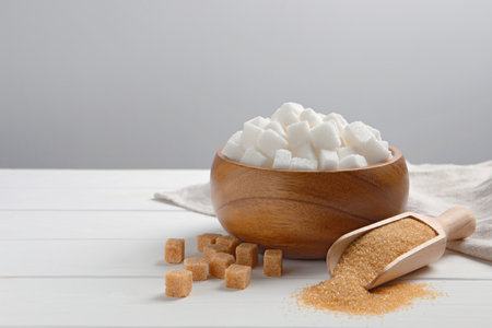 Different types of sugar on white wooden table, space for textの写真素材