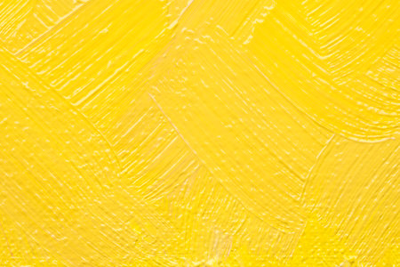 Beautiful strokes of yellow oil paint as background, closeupの写真素材