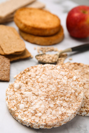 Rice cakes and rusks on white marble table, closeupの写真素材