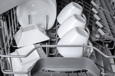 Open modern dishwasher with clean tableware, closeupの写真素材