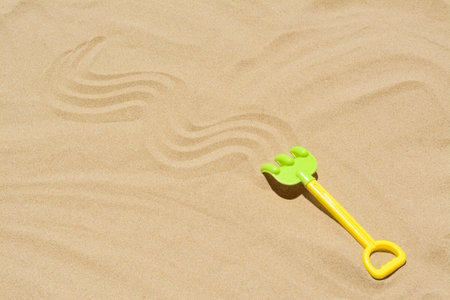 Plastic rake on sand, space for text. beach toyの写真素材
