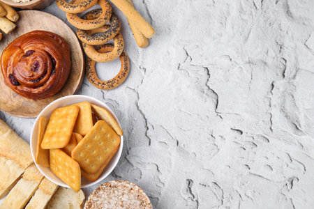 Different gluten free products on light gray textured table, flat lay. Space for text