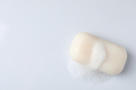 Soap with fluffy foam on white background, top view. Space for textの写真素材