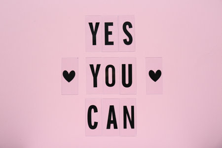 Phrase Yes You Can and hearts on pink background, top view. Motivational quoteの写真素材