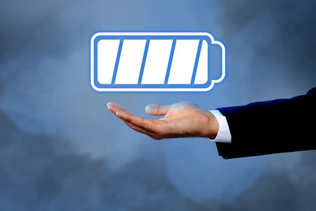 Businessman demonstrating at icon of full battery on color background, closeupの写真素材