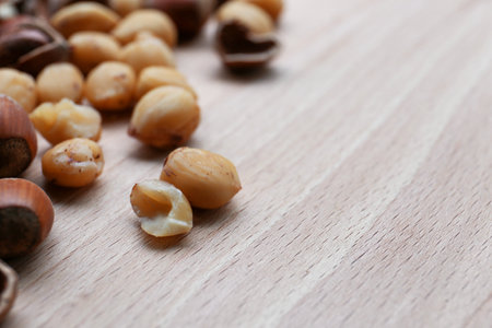 Tasty organic hazelnuts on wooden table, closeup. Space for textの写真素材