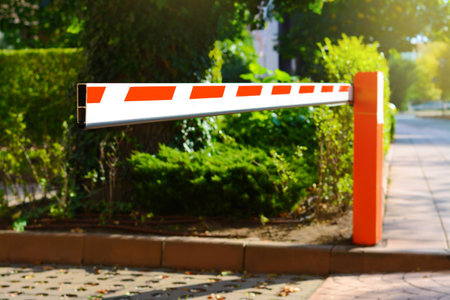 Closed boom barrier on sunny day outdoors