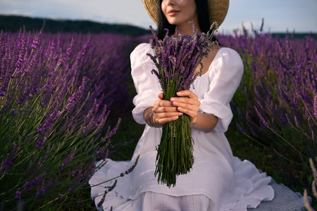 Woman with beautiful bouquet in lavender field, closeupの写真素材