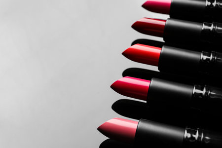 Many bright lipsticks on light gray background, space for textの写真素材