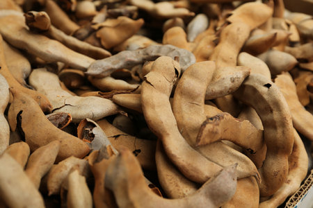 Pile of ripe tamarind fruits as background, closeupの写真素材