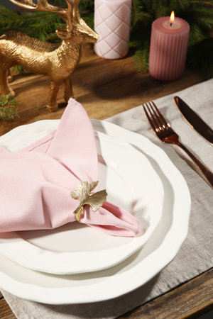 Stylish table setting with pink fabric napkin, beautiful decorative ring and festive decor, closeupの写真素材