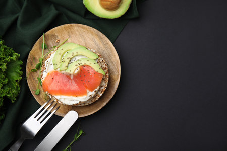 Crunchy buckwheat cakes served with cream cheese, salmon and avocado on table, flat lay. Space for textの写真素材