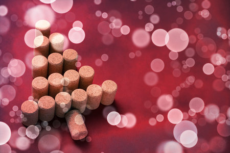 Christmas tree made of wine corks on red backgroundの写真素材