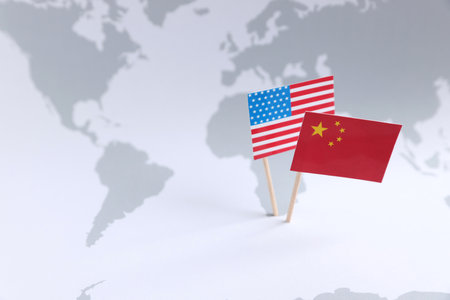 American and Chinese flags on world map, space for text. trade war concept