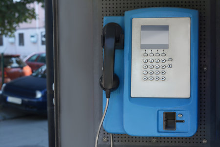 Pay phone on city street, closeup. Space for textの写真素材