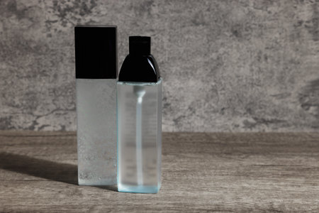 Luxury cosmetic products on wooden table, space for text