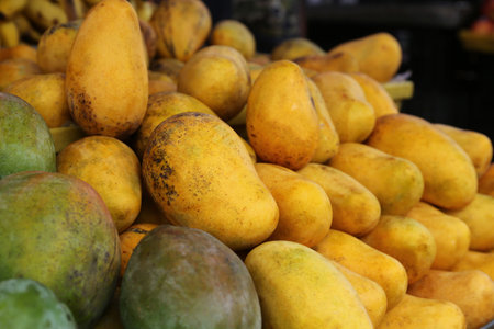 Pile of delicious ripe yellow mangoes, closeupの写真素材