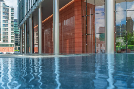 Clean water in fountain near buildings in cityの写真素材