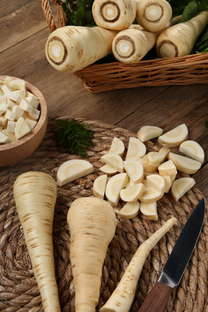 Whole and cut parsnips on wooden table, above viewの写真素材