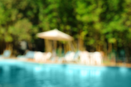 Blurred view of luxury pool and trees outdoors