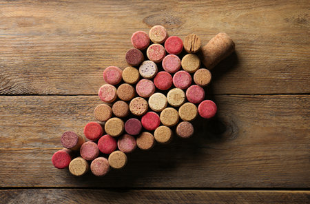 Grape made of wine bottle corks on wooden table, top viewの写真素材