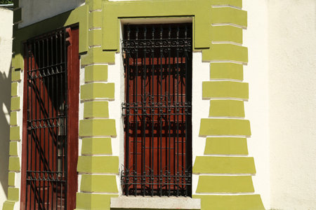 Beautiful door and window with grills on building, view from outdoors