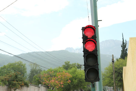 Traffic lights and beautiful mountains on background, space for text