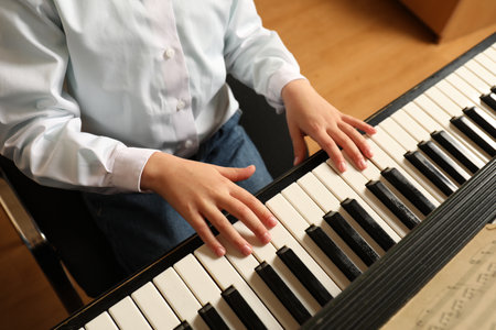 Little child playing piano, above view. music lessonsの写真素材