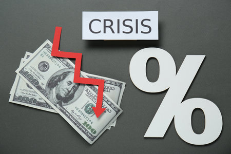 Paper sheet with word Crisis, money, percent sign and descending red arrow on gray background, flat...