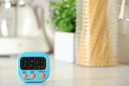 Digital kitchen timer on white table indoors. Space for textの写真素材