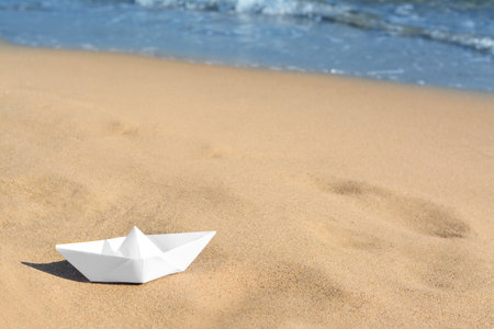 White paper boat near sea on sunny day, space for textの写真素材