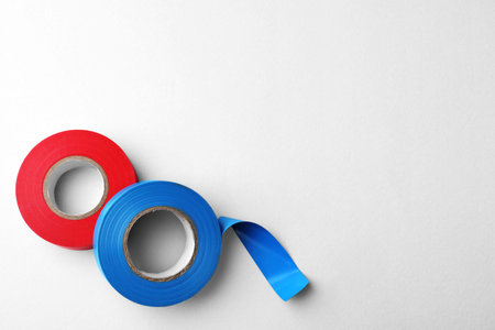 Colorful insulating tapes on white background, flat lay. Space for textの写真素材