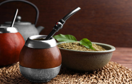 Calabashes with mate tea and bombilla on table