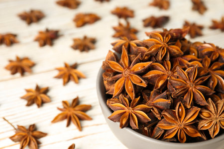 Many aromatic anise stars on white wooden table, closeupの写真素材